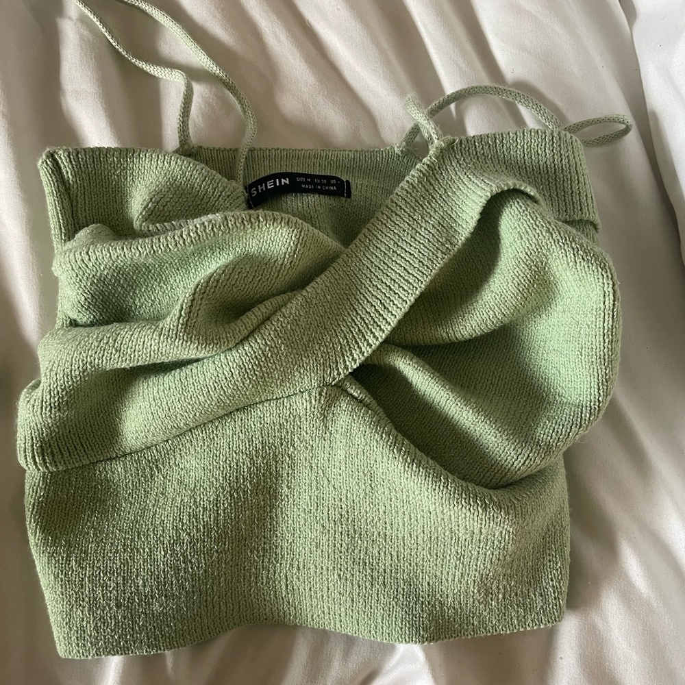 Cropped cross over green top.